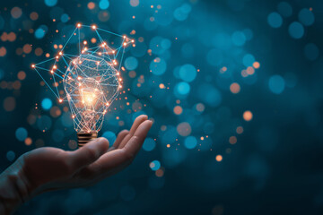 Poster - A hand is holding a light bulb that is glowing