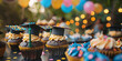 © MNStudio - Graduation party dessert table with small cupcakes, each topped with miniature graduation cap, symbolizing celebration and academic achievement.