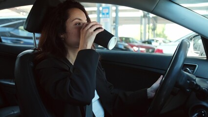 Pretty woman driving in new auto, business concept