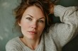 © anatolir - Closeup of a thoughtful woman wearing a knitted sweater, exuding calmness and warmth