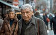 © imagineRbc - An elderly man with grey hair is walking alone along a busy city street, surrounded by tall buildings and pedestrians