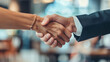 © Jaroon - Close-up of a coworker shaking hands in the office.