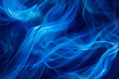 Abstract image featuring electric blue smoke waves swirling against a deep blue background, conveying a sense of fluid motion