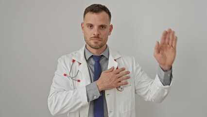 Sticker - Serious man in doctor uniform with stethoscope poses against a white wall, showing professional confidence.