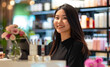 © Irina.Pl - Smiling Asian woman working at a cosmetics store counter