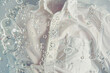 White shirt washed in water with soap bubbles on clean background