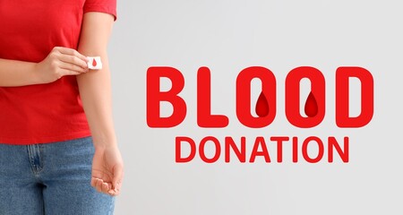 Canvas Print - Female donor applying gauze on her arm against light background, closeup. Banner for World Blood Donor Day