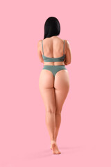 Canvas Print - Young woman in underwear on pink background, back view