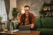 © Miljan Živković - Adult man sit on sofa have consultation via video call about medicines