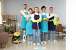 © Pixel-Shot - Group of young janitors with cleaning supplies in office