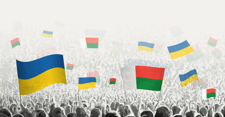 Sticker - People waving flag of Madagascar and Ukraine, symbolizing Madagascar solidarity for Ukraine.