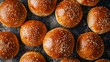 Intimate top view of sesame seed burger buns, emphasizing their crunchy seeds and soft texture, set on an isolated background