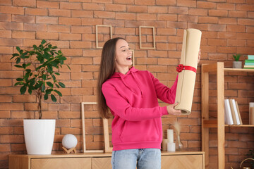 Sticker - Happy young woman with gift fitness mat at home