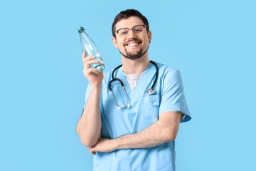 Sticker - Male doctor with bottle of water on blue background