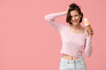 Poster - Beautiful young woman with sweet ice-cream in waffle cone on pink background