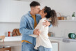 © Pixel-Shot - Happy young beautiful couple kissing at home