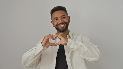 Canvas Print - Young african american man standing isolated over white background, wearing a shirt and showing a heart symbol with hands, presenting a shape of love - a conceptual representation of romantic emotion