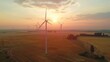 Wind farm field and sunset sky. Wind power. Sustainable, renewable energy. Wind turbines generate electricity.