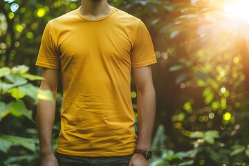 Wall Mural - Young man wearing yellow tshirt for mockup on blurred bokeh background.