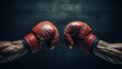 © admin_design - A pair of red boxing gloves are shown in front of a dark background. The gloves are positioned as if they are about to strike each other.
