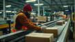 © Nelson - Worker Scanning Packages on Conveyor Belt in Warehouse