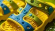 Close-up of foam toddler sandals, featuring fun bright colors such as yellow and green, soft texture highlighted under studio lighting