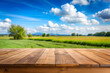 The empty wooden brown table top with blur background of farmland
