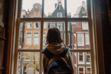 Poster - Woman looking out of a window at urban buildings. Ideal for cityscape concepts