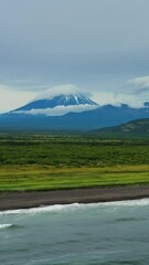 Wall Mural - aerial view of khalaktyrsky beach with black sand and volcano on kamchatka peninsula, russia, pacifi
