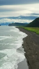 Wall Mural - flying over khalaktyrsky beach with black sand on kamchatka peninsula, russia, pacific ocean. vertic