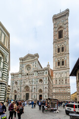 Wall Mural - Florence, Italy - April 10, 2024: Florence cathedral with surrounding area full of tourists in Florence, Italy