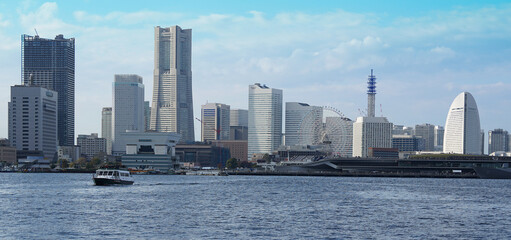 Modern skyscrapers and seascape standing in the port city of Yokohama, Japan on a sunny day