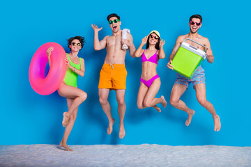 Sticker - Full length photo of positive impressed buddies company dressed bikini going picnic jumping high isolated blue color background