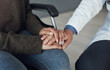 © peopleimages.com - Doctor, patient and holding hands for medical support in hospital office with closeup, empathy and kindness. Professional, expert and woman with sympathy for healthcare results, diagnosis and health