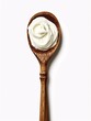 © ckybe - A wooden ladle with fresh cream on a white background.