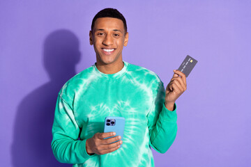 Sticker - Photo of handsome good mood guy wear teal sweatshirt online banking modern gadget isolated purple color background