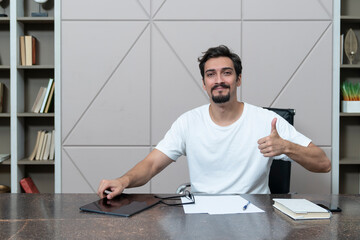 Wall Mural - Young positive freelancer working in the office