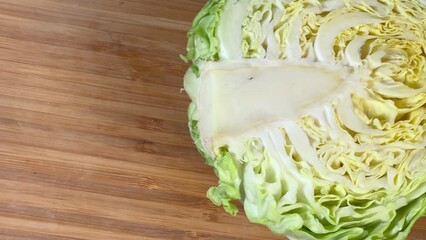 Wall Mural - Top view of half of white cabbage on cutting board