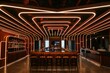 © anatolir - Stylish and contemporary bar ambiance with dynamic red and orange neon lights in a dark setting