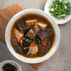 Sticker - Spicy duck blood jelly soup and stinky tofu with scallion and chili pepper topping.