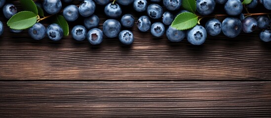 Poster - A top down view of fresh blueberries is captured against a rustic wooden background providing ample room for writing or graphics