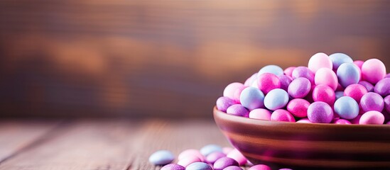 Aufkleber - The wooden background showcases a bowl filled with round candies in shades of purple and pink leaving ample space for additional content or graphics
