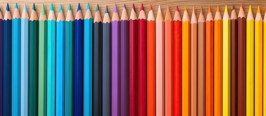 Aufkleber - A vibrant copy space image displaying a wooden wall adorned with an array of colorful pencils