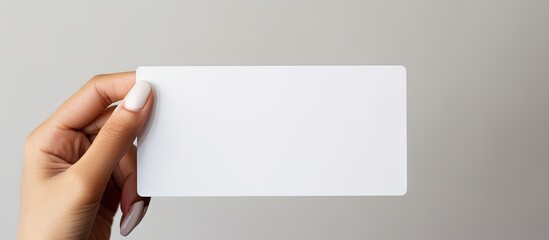 Poster - A white prepaid card is held by a woman s hand against a white background with ample empty space for additional images or text