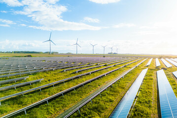 wind turbines and solar panels farm in a field. renewable green energy. sunny landscape, electric en