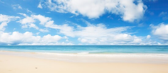 Poster - Tranquil serene landscape featuring a wide empty sand beach adorned by a beautiful cloudy sky offering a perfect atmosphere for relaxation Ample copy space image available for creative usage