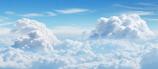 Poster - The spacious blue sky is adorned with large billowing white clouds creating an ideal copy space for adding text