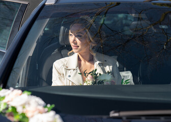 Wall Mural - Wedding photo of the bride in the car through the glass