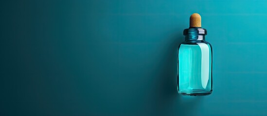 Aufkleber - Turquoise background showcases a bottle of medical drops creating ample copy space for text