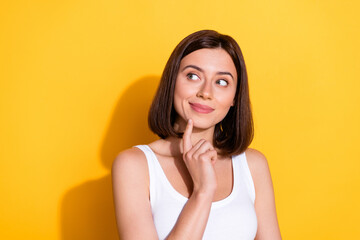 Poster - Photo portrait of attractive young girl look interested empty space wear trendy white outfit isolated on yellow color background